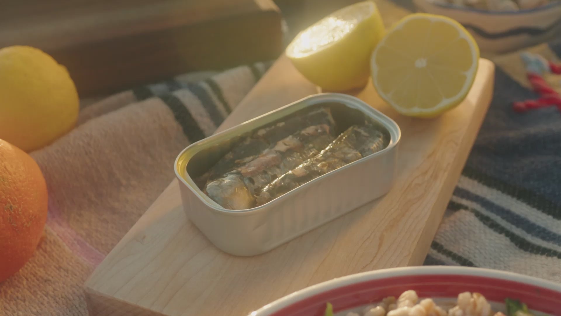 Load video: Beach picnic with friends sharing Skin & Bone sardines in olive oil